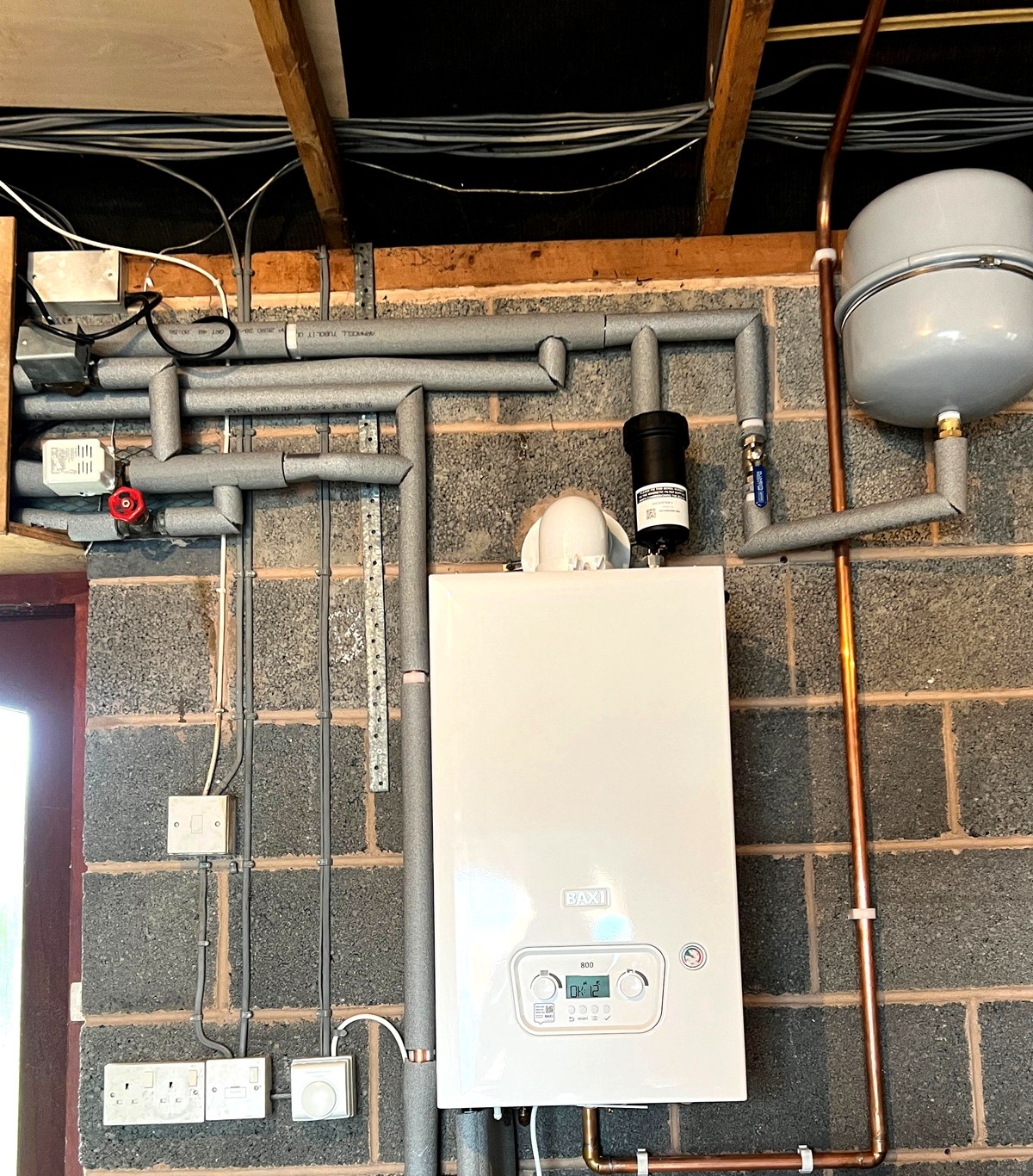 Baxi boiler installation in a utility room with pipework